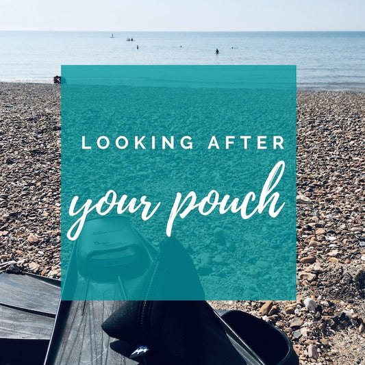 Looking After Your Neoprene Pouch. Image of neoprene pouch on a pair of dive fins on a stoney beach.